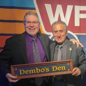 Benjamin Rifkin and Stephen Dembowski holding Dembo's Den sign