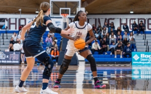 a student-athlete on a basketball court during a game.