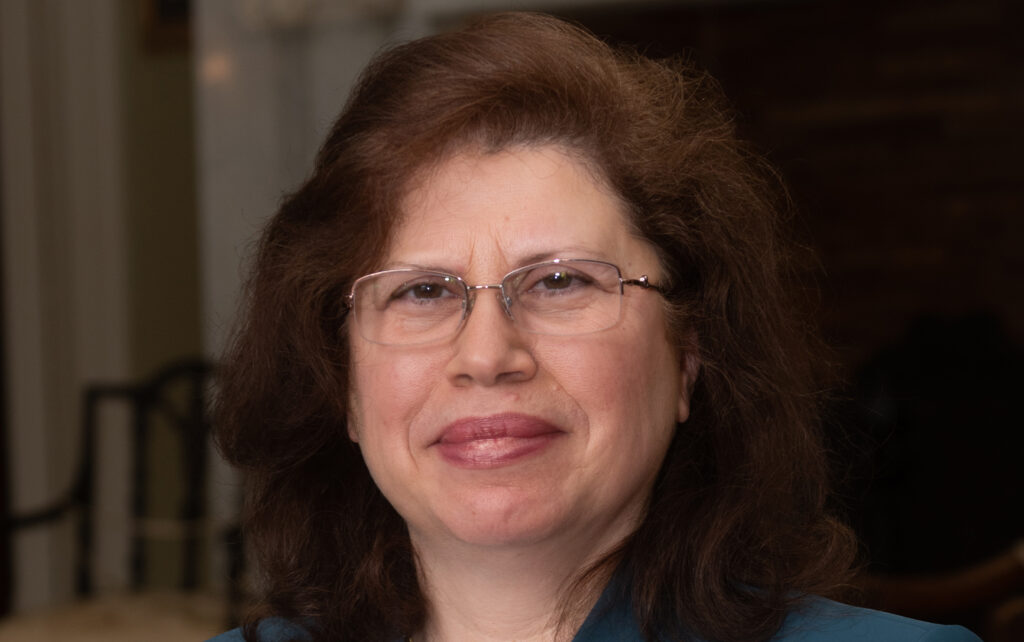 a headshot of a woman wearing glasses.