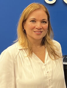 Smiling woman wearing an offwhite top