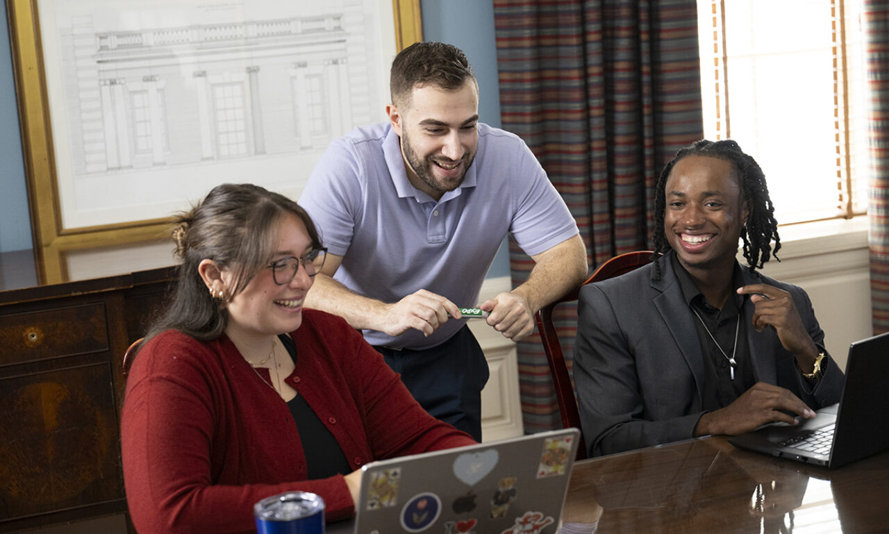 3 people working on laptops