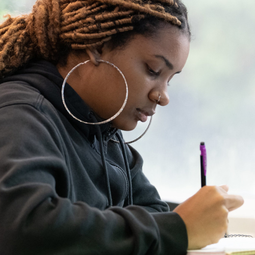 Students take notes in class.