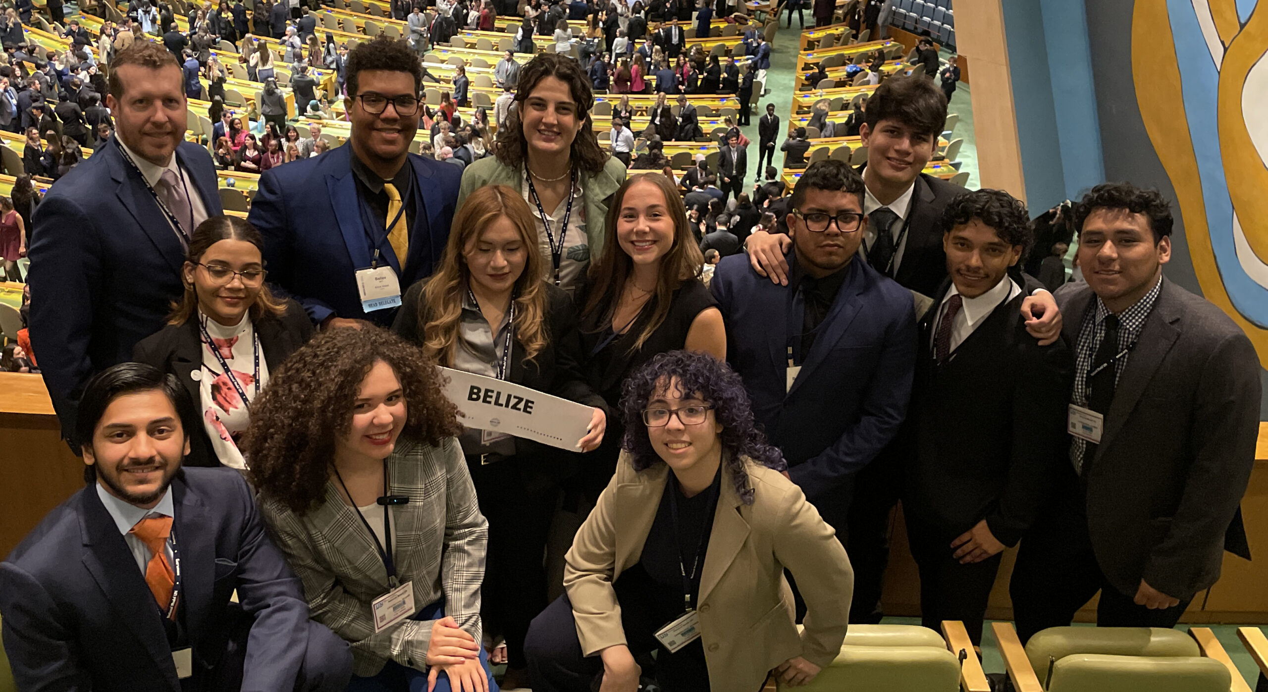 A group of smiling people in the United Nations headquaters.