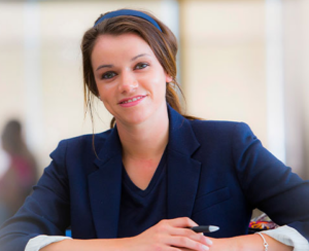 a student smiles at the camera.