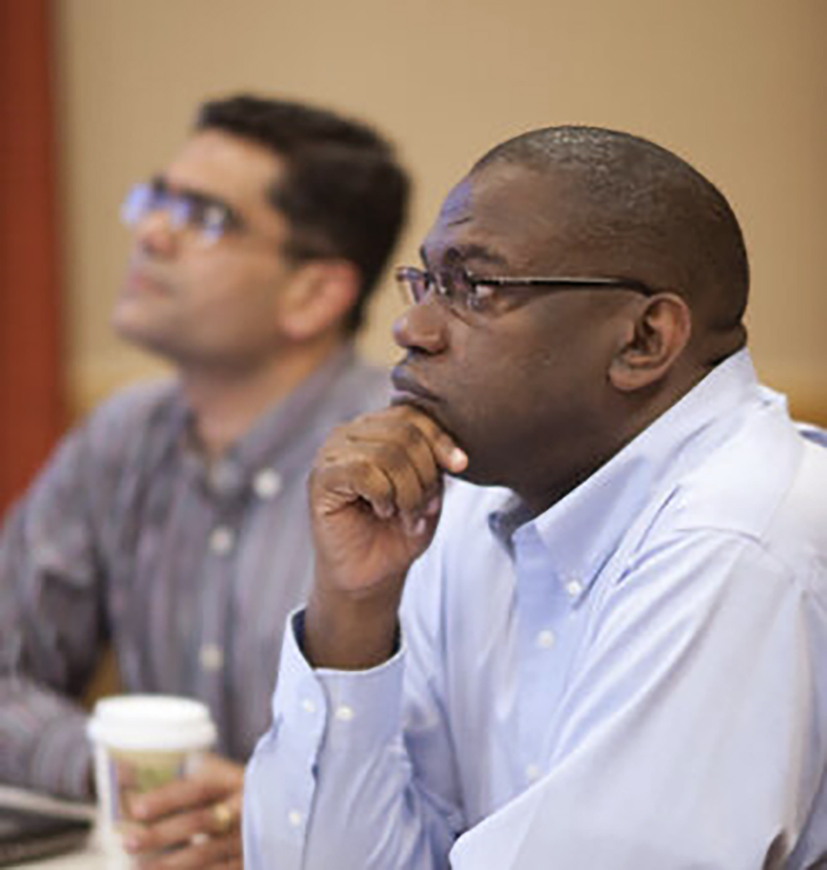 a man listens to someone out of frame.