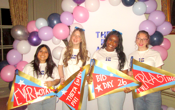 Four smiling women at Bid Day.