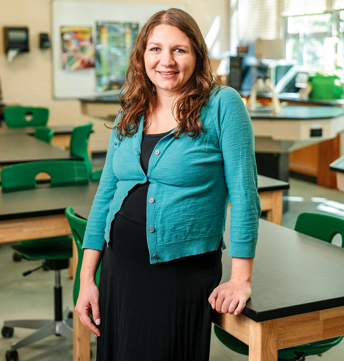 A female teacher stands in her science classroom.