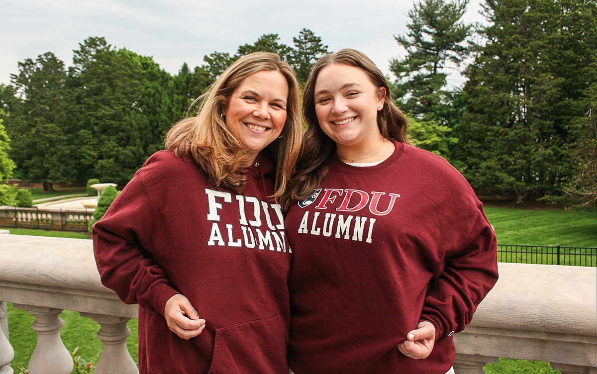 A mom and daughter wear matching FDU sweatshirts.