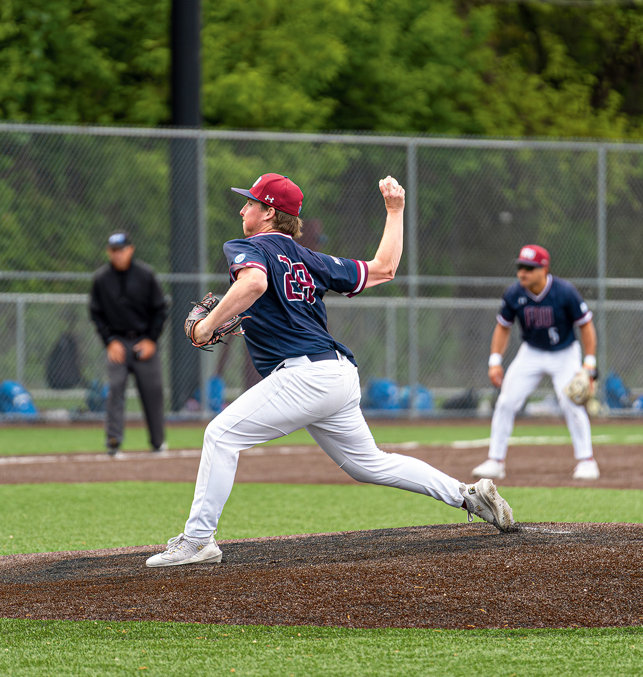 A baseball pitcher on the mound.