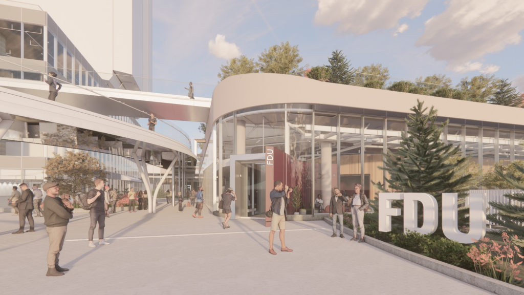 An architectural rendering of a modern FDU (Fairleigh Dickinson University) building complex. The design features contemporary architecture with curved structures, extensive glass facades, elevated walkways with people on multiple levels, and a spacious plaza area. Large white "FDU" letters serve as prominent signage near the entrance. The scene includes rendered figures of people walking and gathering in the outdoor spaces, surrounded by landscaping with trees and plantings. The building showcases sustainable design elements with visible green roofs and natural lighting throughout the transparent walls.