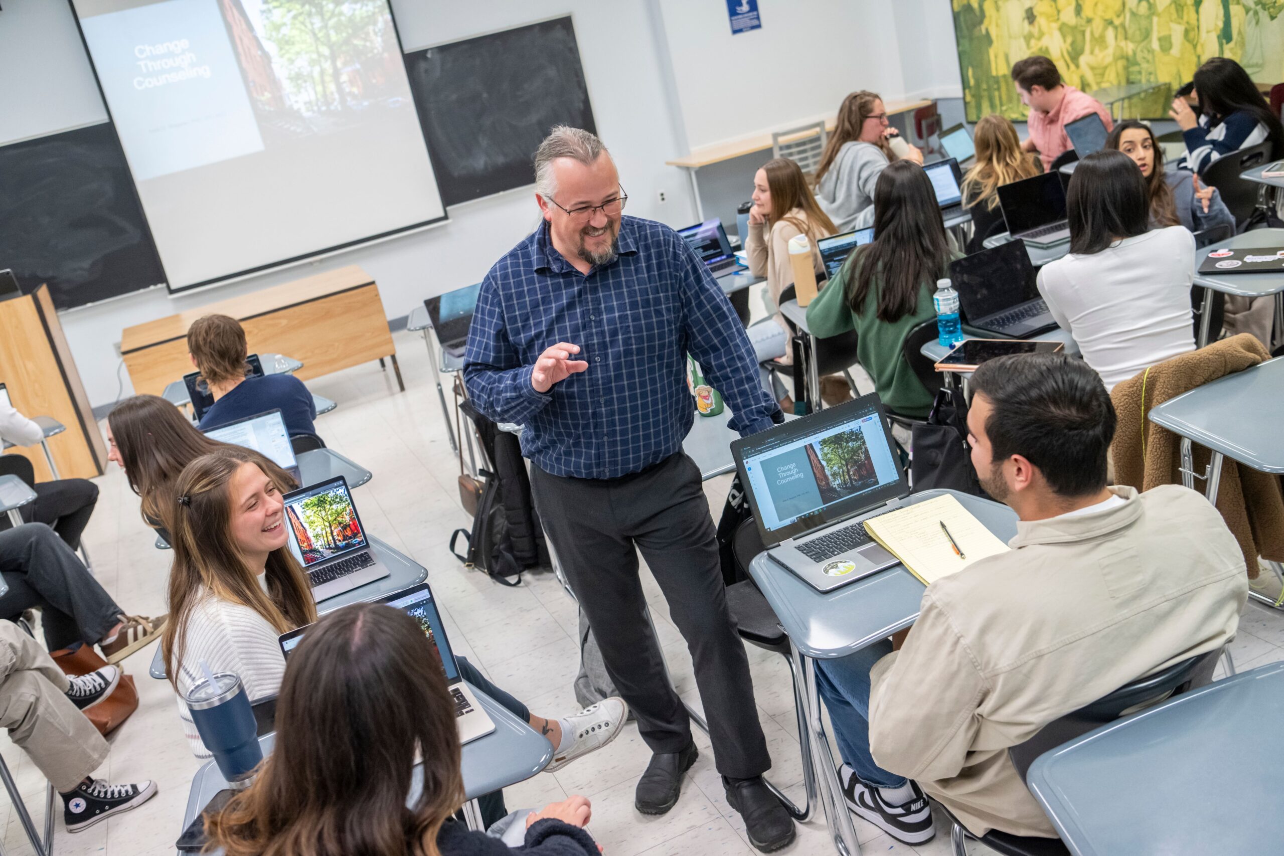 a professor speaks to students in the middle of class.