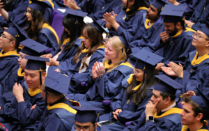 Graduate alumni celebrating during graduation ceremony