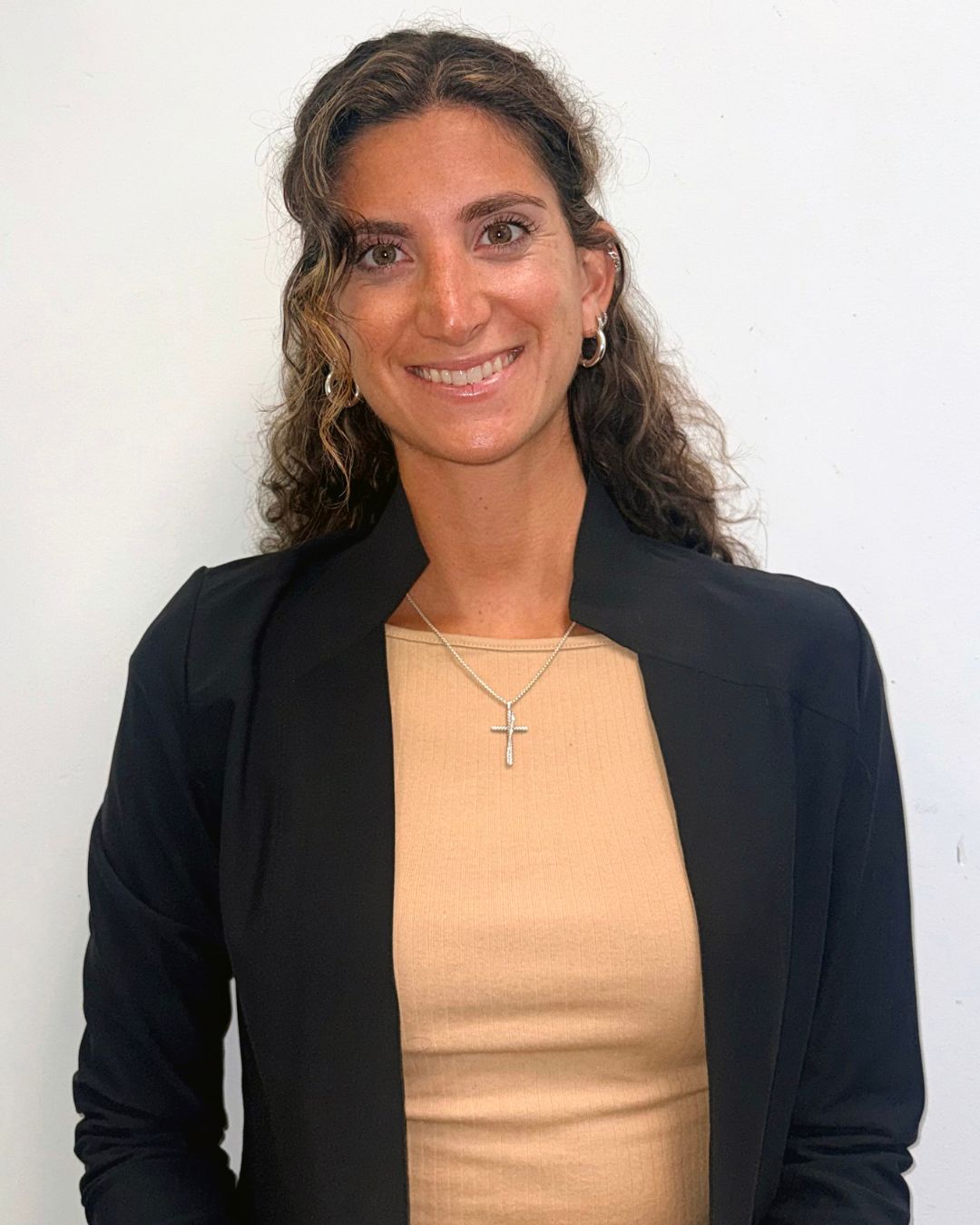a headshot of a woman. she wears a black jacket.