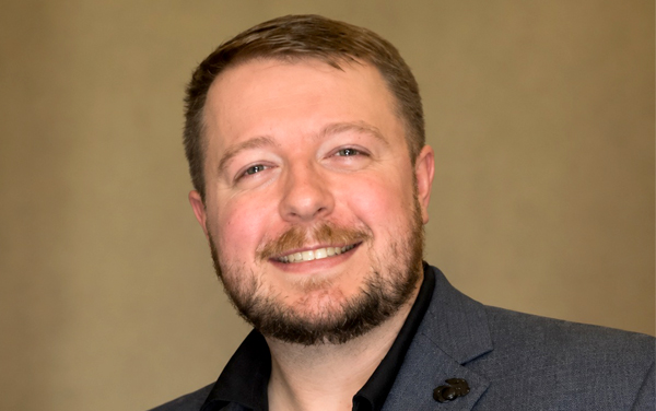 Smiling man wearing gray suit