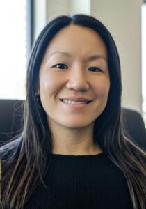 Smiling woman in black blazer and top